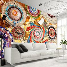 a living room with a white couch and large wall mural