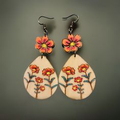 Boho Floral Wooden Earrings – Hand-Painted & Nature-Inspired Celebrate your love of nature with these beautiful wooden earrings featuring hand-painted floral motifs. Each flower is carefully engraved and painted on lightweight wood treated with linseed oil for durability. These 2-inch long earrings are the perfect accessory for you who embrace a minimalist and bohemian style without losing elegance. The picture may not reflect the actual color of the items due to differences in screen's pixel. Handmade Natural Wood Earrings, Bohemian Multicolor Floral Print Earrings, Bohemian Multicolor Hand Painted Flower Earrings, Unique Hand Painted Flower Drop Earrings, Artsy Hand Painted Flower Earrings, Bohemian Drop Earrings With Floral Print, Bohemian Floral Print Drop Earrings, Bohemian Hand Painted Flower Earrings, Nature-inspired Hand Painted Drop Earrings