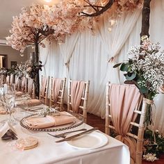 the table is set with pink napkins and place settings for an elegant wedding reception