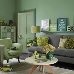 a living room filled with furniture and green walls