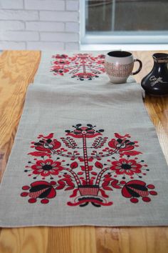 a table with a place mat and two cups on it, sitting next to each other