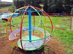 an outdoor playground with swings and slides