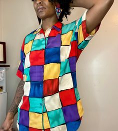 Fabulous multi colored button down top! Beautiful & bright colors! Shoulder pads.  Tag has been removed, but fits like an XL Measurements (measured flat): Shirt length 30 inches long Sleeve length 9.8 inches Bust 21 inches  In Excellent vintage condition!  No rips or tears.  Model is 5'9 in height and wears a size medium top Multicolor Summer Shirt With Colorful Pattern, Summer Multicolor Shirt With Colorful Pattern, Multicolor Short Sleeve Shirt With Vibrant Print, Multicolor Vibrant Print Short Sleeve Shirt, Vibrant Multicolor Short Sleeve Shirt, Casual Multicolor Shirt With Vibrant Print, Multicolor Collared Shirt With Vibrant Print, Fun Multicolor Short Sleeve Shirt, Casual Multicolor Rainbow Print Shirt