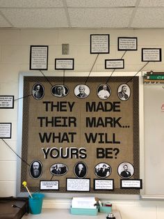 a bulletin board with some writing on it and many pictures hanging from the wall behind it