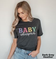 a woman wearing a baby whisperer t - shirt with the words, dark grey heather