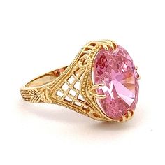 Large Oval Pink Cubic Zirconia Yellow Gold Filigree Ring Ring Size: 7.75 Metal Content: 14k Yellow Gold Gemstone: Cubic Zirconia Carat: 5 Size in mm: 14 x 10 Weight: 5.7 Grams Back of Ring width: 2mm Stamps: 14k DQCZ Condition: Excellent Pre-owned Condition Each piece is thoroughly examined and refinished as needed by our professional jewelers, tested to guarantee metal content,  graded by our in-house GIA (Gemological Institute of America) Graduate Gemologist, and inspected for quality before being carefully packaged and promptly shipped. Thank you for taking the time to shop with us! We have hundreds of more listings, with more being added every week! From necklaces to bracelets, the classics and trendy.  We are likely to have something you and your loved ones will cherish. Please contac Classic 14k Gold Filigree Ring In Oval Shape, Oval Diamond Cut Topaz Ring Fine Jewelry, Oval Diamond Cut Topaz Ring In Fine Jewelry Style, Oval Gold Topaz Ring With Diamond Cut, Oval Diamond Cut Topaz Ring, 14k Gold Oval Filigree Promise Ring, Fine Jewelry Oval Diamond Cut Topaz Ring, Oval 14k Gold Filigree Ring For Gift, Oval Pink Gold Jewelry For Anniversary