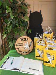 there are many small bags on the table with books and pens in front of them