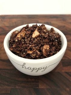 a bowl filled with granola sitting on top of a wooden table