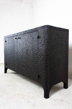 a black cabinet with two doors on the front and one door open to reveal something