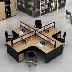 an office cubicle with two desks, chairs and laptops on the table