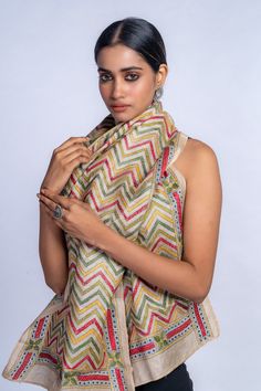 "Fabric: Hand woven pure Tussar silk. Embroidery style: Kantha embroidery from Bengal, India. Threads for embroidery: Premium quality cotton threads. Design patterns: Colourful Chevron Dimension: 72\" x 22\" approximately. Care: Dry wash & Polish. Note: As the product is hand embroidered, it may have minor irregularities that are the natural outcome of human involvement in the process & exudes beauty that is distict. Indulge in the timeless allure of our Kantha embroidered in pure Tussar silk st Bohemian Designer Slub Silk Dupatta, Festive Fusion Dupatta With Resham Embroidery, Fusion Style Multicolor Dupatta With Zari Work, Fusion Style Multicolor Dupatta In Traditional Drape, Multicolor Fusion Dupatta In Traditional Drape, Multicolor Fusion Dupatta With Traditional Drape, Fusion Style Dupatta With Resham Embroidery For Festivals, Bohemian Dupatta With Cutdana For Designer Wear, Fusion Style Dupatta With Resham Embroidery