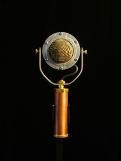 an old fashioned microphone on a black background