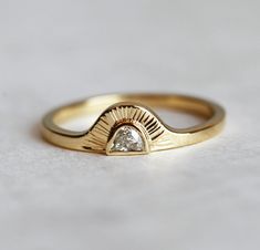 a gold ring with a white diamond in the middle