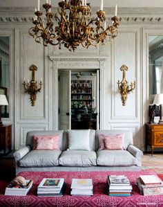 a living room filled with furniture and a chandelier