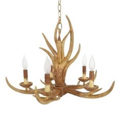 a chandelier with antlers hanging from it's center and four candles in the middle