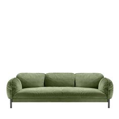 a green couch sitting on top of a white floor