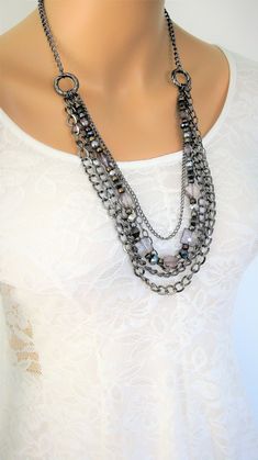 "Multi Strand Grey and Gunmetal Beaded Necklace, handmade by Ralston Originals. This beaded necklace includes a collection of beautiful crystal, glass, metal, and acrylic beads, in grey, silver, and black. The chain is gunmetal, and has multi strands of 4 different sizes and types of chain. This beaded necklace is 32 inches long, has a lobster clasp, and 3 inch extension chain. This black and grey beaded necklace is ready to send today, and it includes free shipping in the USA. I carefully packa Silver Faceted Beads Metal Beaded Necklaces, Silver Metal Beaded Necklace With Faceted Beads, Silver Beaded Metal Crystal Necklaces, Silver Beaded Metal Crystal Necklace, Silver Beaded Crystal Costume Necklace, Silver Crystal Beaded Necklaces With Colorful Beads, Silver Crystal Beaded Necklace With Colorful Beads, Silver Beaded Necklaces With Colorful Crystal Beads, Silver Multi-strand Crystal Beaded Necklaces