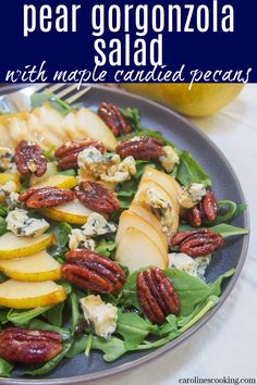 a salad with apples, pecans and blue cheese on top is shown in this image