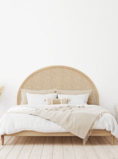 the bed is made up with white linens and pillows on it, along with two side tables