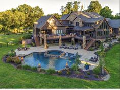 an aerial view of a large home with a pool and hot tub in the yard