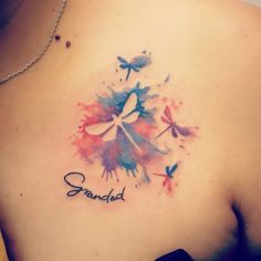 a woman's chest with the words grandad and dragonflies painted on it