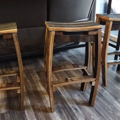 two wooden stools sitting next to each other on top of a hard wood floor