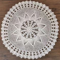 a white doily sitting on top of a wooden table