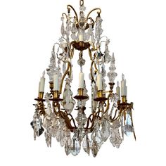 an antique chandelier with many crystal pieces hanging from it's centerpiece