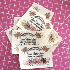 four embroidered labels with flowers on them