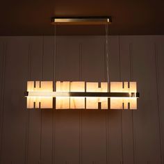 a modern light fixture hanging from the ceiling