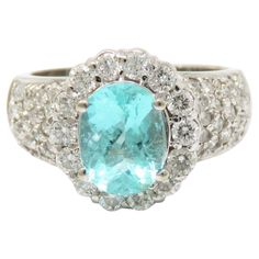 an aqua and white gold ring with diamonds on the sides, set in 18k white gold