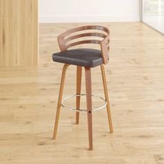 a wooden bar stool sitting on top of a hard wood floor