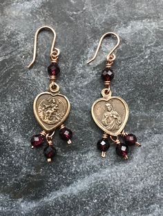 Catholic Earrings - Sacred Heart and Scapular Earrings Bronze wire and medals Garnet gemstones Catholic Jewelry, Jewelry Lookbook, Garnet Gemstone, Jewelry Inspo, Sacred Heart, Pretty Jewellery, Heart Jewelry, Star Earrings, Piercing Jewelry