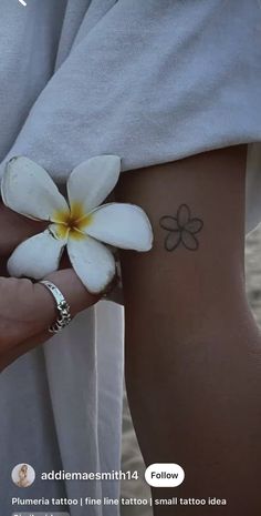 a woman's arm with a flower tattoo on her left side, and the words follow above it