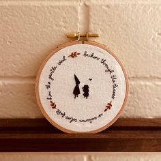 a hand embroidered hoop hanging on a wall with a quote from the movie winnie - pooh