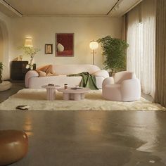 a living room filled with lots of furniture next to a wall covered in pictures and plants