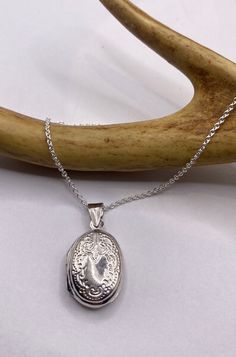 "Vintage Silver Locket Necklace  The Tiny Oval Photo Locket measures about 1/2 inch long (without the bale), features a lovely etched design and is the perfect necklace for a small photo or other memory  Paired with a delicate 925 Sterling Silver Chain available in lengths of 16, 18 ,20, 22\" or 24\" We recommend using a laminated photo for longevity  Thank you for supporting a small veteran owned business! All jewelry is shipped free within the US in a stylish gift box" Silver Stamped Oval Pendant Jewelry, Sterling Silver Locket Necklace With Oval Link For Gifts, Sterling Silver Oval Locket Necklace Gift, Oval Etched Jewelry For Anniversary, Silver Sterling Silver Locket Necklace With Oval Link, Sterling Silver Oval Link Jewelry Stamped 925, Classic Silver Locket Necklace With Oval Link, Classic Silver Oval Link Locket Necklace, Classic Sterling Silver Oval Link Locket Necklace