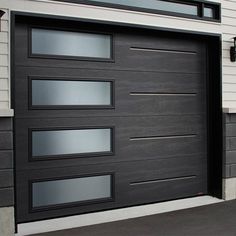 a black garage door with glass panels on the side