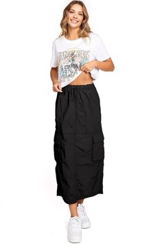 Chic, parachute skirt with an elastic waistband, a drawstring cinch tie and cargo pockets down the sides. Pair it with a graphic tee and sneakers for an effortless streetwear look. CARE | Machine Wash Cold CONTENTS | 100% Nylon MEASUREMENTS | 33"/85 cm Top to Bottom (Size Small) MODEL | 5'8 - wearing a size Small IMPORTED Summer Streetwear Cargo Skirt, Casual Black Cargo Skirt For Summer, Casual Baggy Cargo Skirt For Spring, Cotton Cargo Skirt For Summer Streetwear, Summer Cotton Cargo Skirt For Streetwear, Trendy Cotton Cargo Skirt For Streetwear, Summer Streetwear Cotton Cargo Skirt, 90s Summer Parachute Pants With Cargo Pockets, Spring Cargo Skirt With Pockets For Streetwear