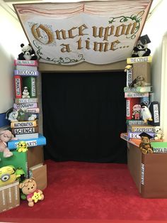 there are many stuffed animals on display in this room with the sign over it that says once upon a time