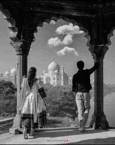 black and white photograph of man and woman looking at the taj