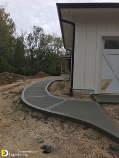 a house with a curved walkway leading up to the front door and side of it