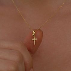 Our 14K Solid Gold Cross Necklace is meticulously designed for women and is also suitable for girls of all ages. This Christian necklace, with its crucifix pendant, is the perfect gift for girls, whether you're commemorating a special occasion or simply expressing your faith. PRODUCT DETAILS: Material: 14K Solid Gold Gemstone: Cubic Zirconia Closure: Spring ring Chain style: Cable Style: Minimalist Dainty Yellow Gold Cross Pendant Jewelry, Delicate Yellow Gold Cross Pendant Necklace, Dainty Yellow Gold Cross Necklace Gift, Gold Cross Necklaces, Dainty 14k Gold-filled Cross Necklace, Elegant 14k Gold-filled Cross Pendant Necklace, Dainty Cross Necklace, Tiny Cross Necklace, Cross Necklaces