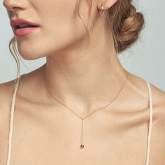 Handcrafted in 14-karat gold, a delicate gold lariat necklace with a solid gold dome dangled forged by hand.  Simple, sleek and understated luxe. Gold Lariat Necklace, Everyday Luxury, Solitaire Necklaces, Keshi Pearls, Beaded Hoop Earrings, Pearl Gemstone, Traditional Jewelry, Ring Size Guide, Lariat Necklace