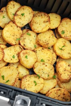 cooked potatoes in an air fryer with parsley on top