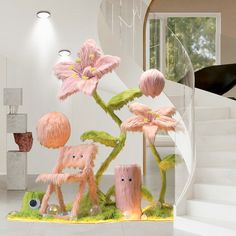 three pink flowers on display in front of a spiral stair case with glass vases