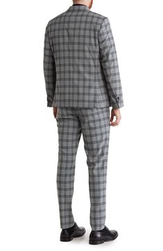 Update your officewear wardrobe with this peaked-lapel suit patterned with a bold plaid print. Blazer has 31" length (size 40R); pants have 32" inseam; 13" front rise (size 34W) Blazer has peaked lapels; four buttons on each cuff; two-button closure; chest welt pocket; front flap pockets Pants have zip fly with hook-and-bar closure; front slant pockets; back welt pockets Lined 69% polyester, 29% rayon, 2% spandex Dry clean Imported Model stats: 6'0" height; 32" waist. Model is wearing size 40R. Plaid Suit With Suit Collar For Work, Tailored Plaid Blazer For Office, Plaid Suits With Welt Pockets And Lapel Collar, Plaid Suits With Welt Pockets, Tailored Plaid Suits For Business Casual, Plaid Single Breasted Suits For Business Casual, Plaid Notch Lapel Suit For Business Casual, Business Casual Suits With Houndstooth Pattern And Notch Lapel, Business Casual Houndstooth Suit With Notch Lapel