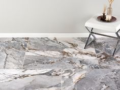 a white chair sitting on top of a floor next to a marble tile flooring