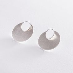 Decorate your outfit with this modern pair of ear jacket earrings. Each earring has a matte piece that hangs behind your lobe for a unique and trendy look. Metal: 925 sterling silver; optional 18k yellow / white / rose gold vermeil Earring diameter: 2.5 cm / 0.98" Backing: post back, clutch backing Hypoallergenic: lead and nickel-free materials used Contemporary Round Earrings, Contemporary Everyday Round Earrings, Contemporary Round Earrings For Everyday, Modern Everyday Circular Earrings, Modern Single Drop Plug Earrings, Contemporary Everyday Drop Earrings, Modern Wrap Drop Earrings For Everyday, Modern Drop Wrap Earrings For Everyday, Modern Everyday Drop Earrings