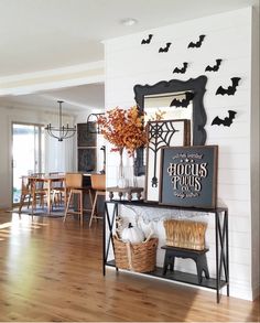 a living room filled with furniture and lots of bats hanging on the wall above it